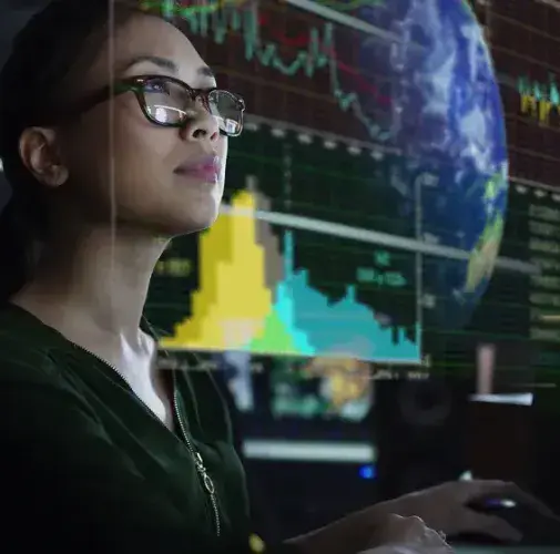 Student analyzing global financial data on screens